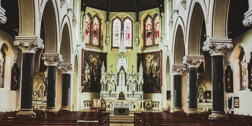 brown wooden chairs inside cathedral